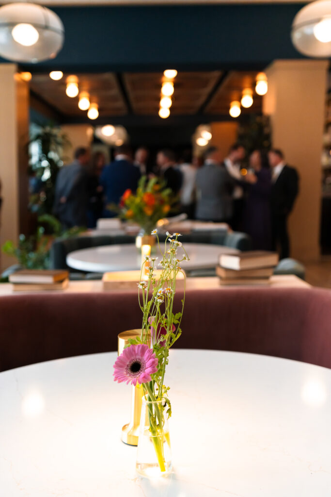 Tabletop floral with guests blurred behind