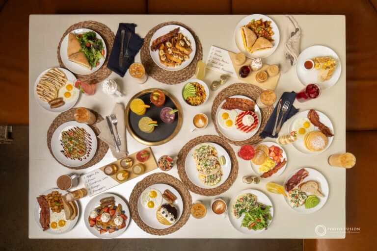 This in a top down image of every food dish and drink that is served at Jojo's Coffeehouse Breakfast & brunch. Everything is laid out on the table