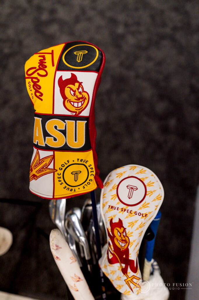Detail of two True Spec Golf headcovers featuring ASU lettering, Sparky and gold pitchfork print