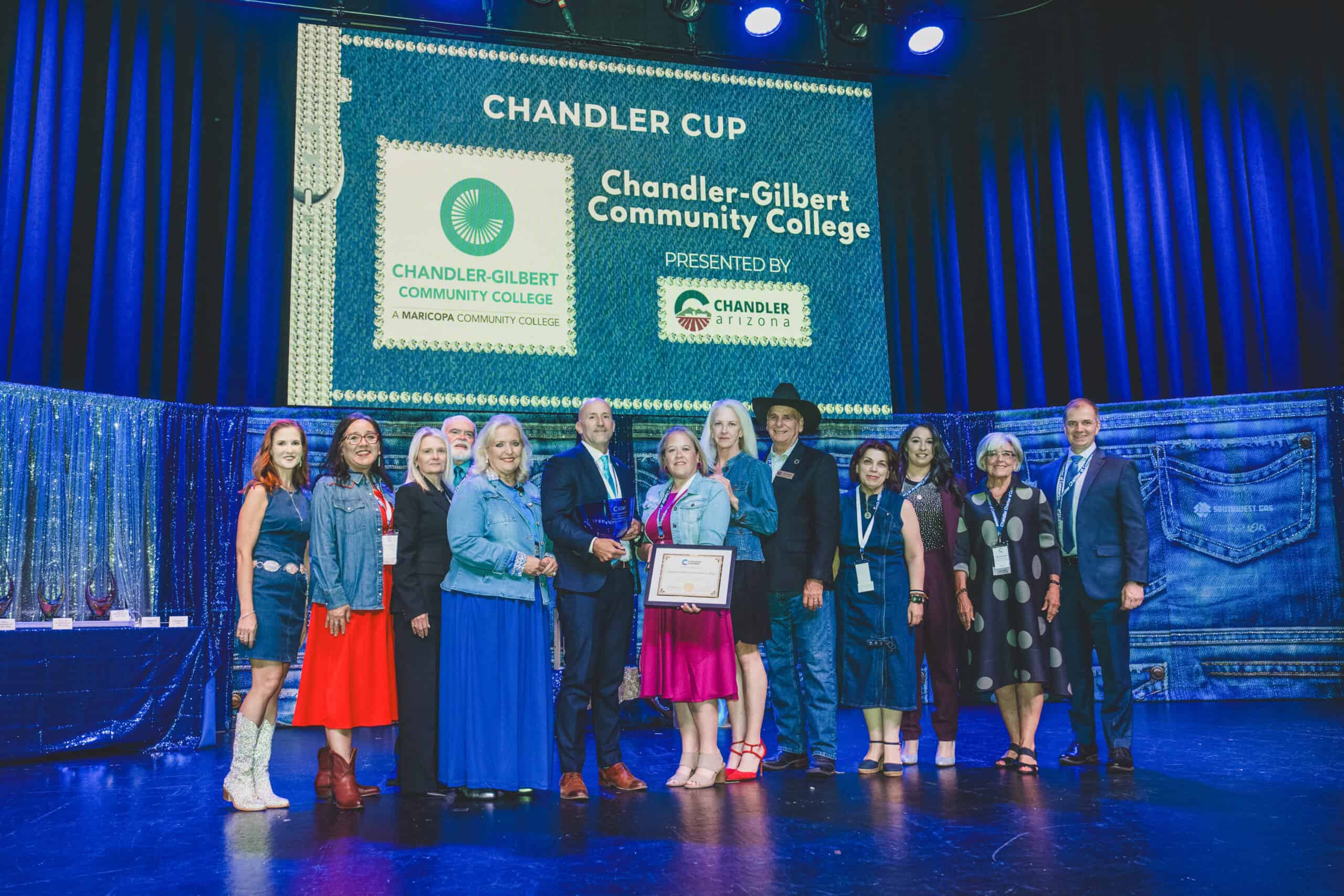 Chandler-Gilbert Community College team accepts the Chandler Cup on stage at the Chandler Chamber Community Awards