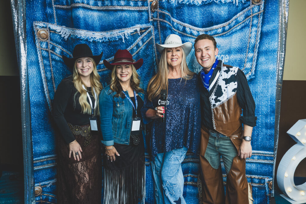 Denise McCreery of d'Vine Gourmet with Cari Gililland and Logan Valentine of Copper Brim Hat Co. at the denim photo backdrop