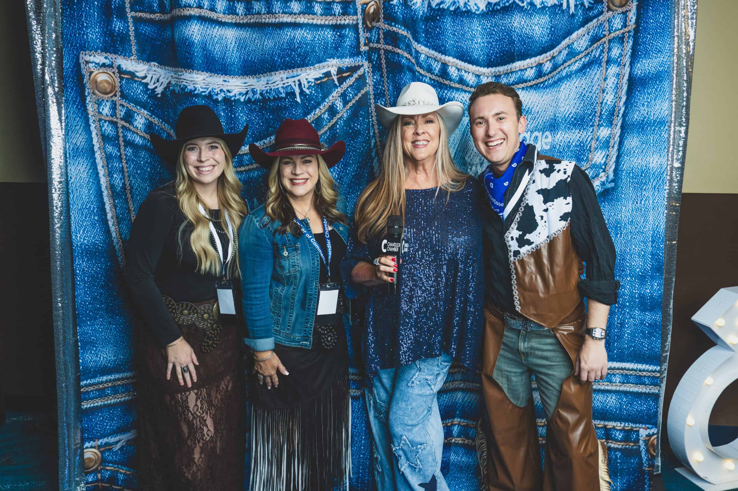 Denise McCreery of d'Vine Gourmet with Cari Gililland and Logan Valentine of Copper Brim Hat Co. at the denim photo backdrop