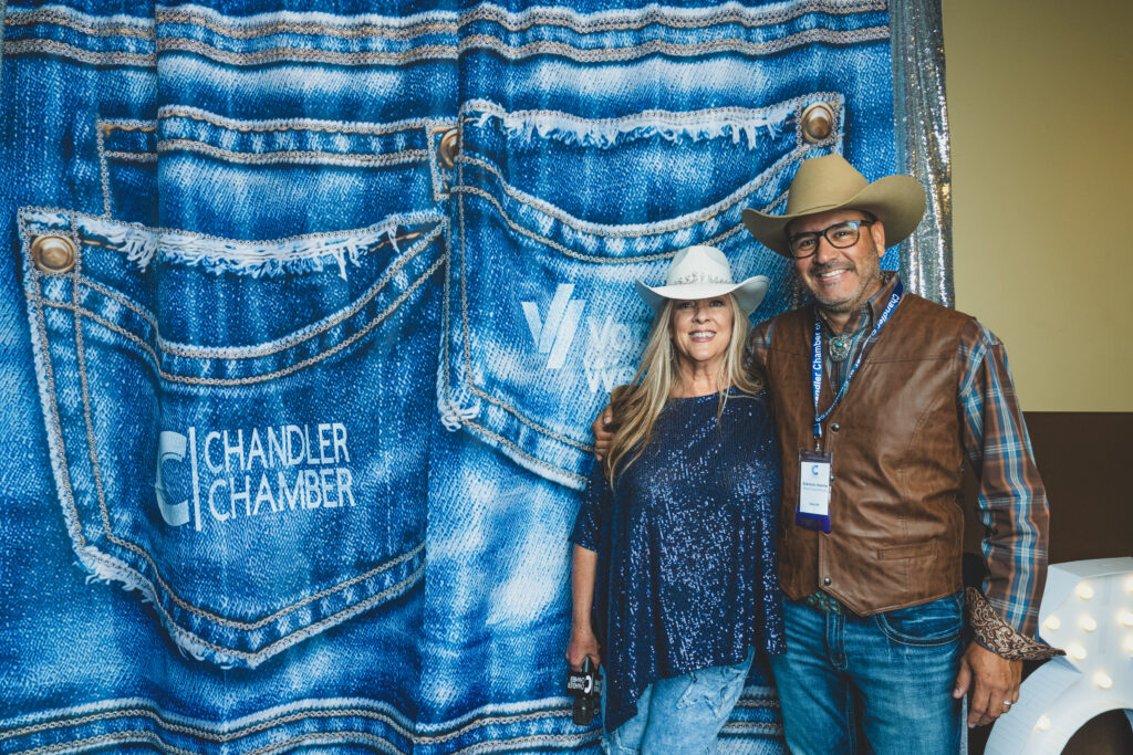 Everardo of Photo Fusion Studio with Denise McCreery of d'Vine Gourmet at the denim photo backdrop