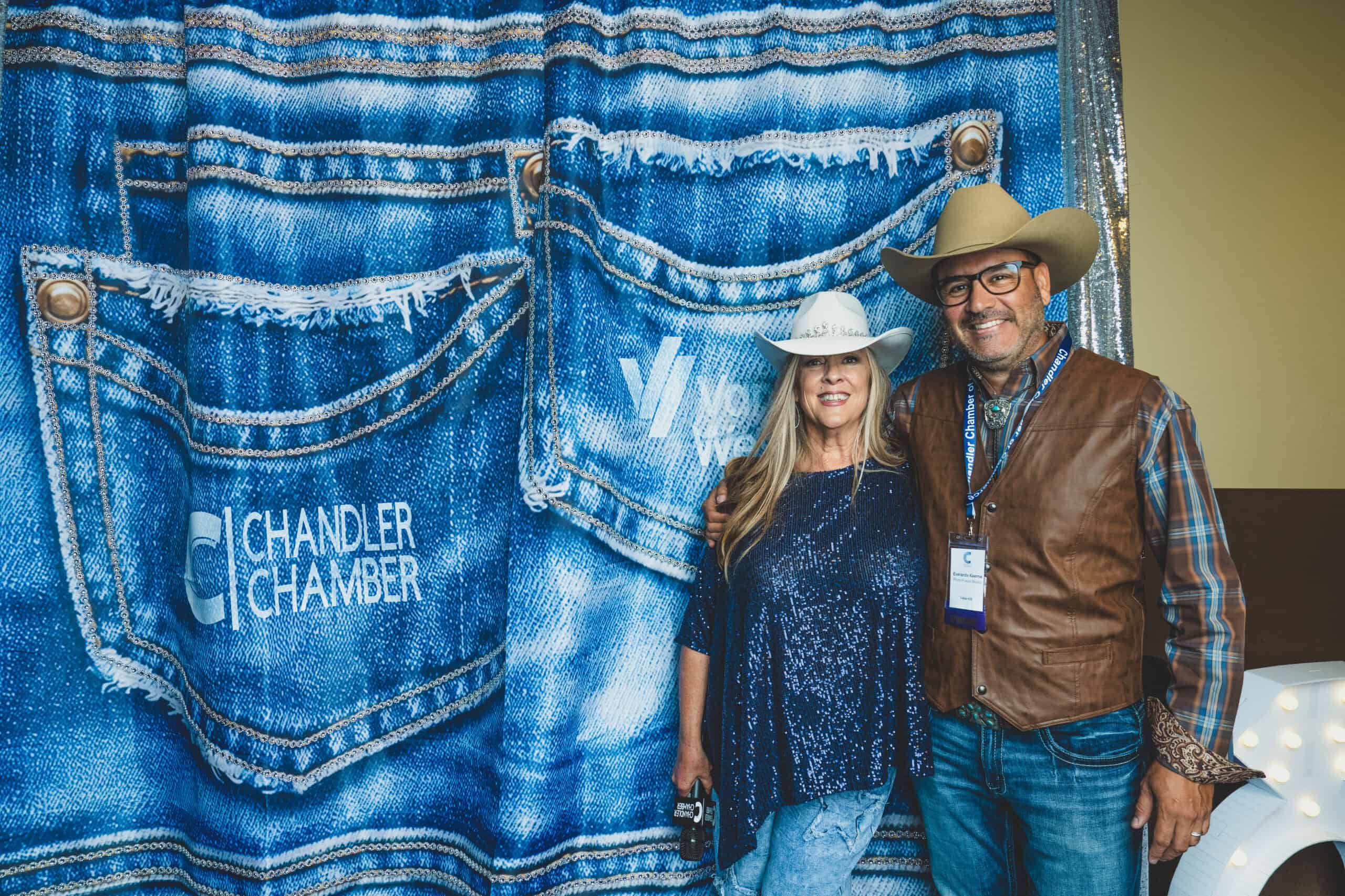 Everardo of Photo Fusion Studio with Denise McCreery of d'Vine Gourmet at the denim photo backdrop