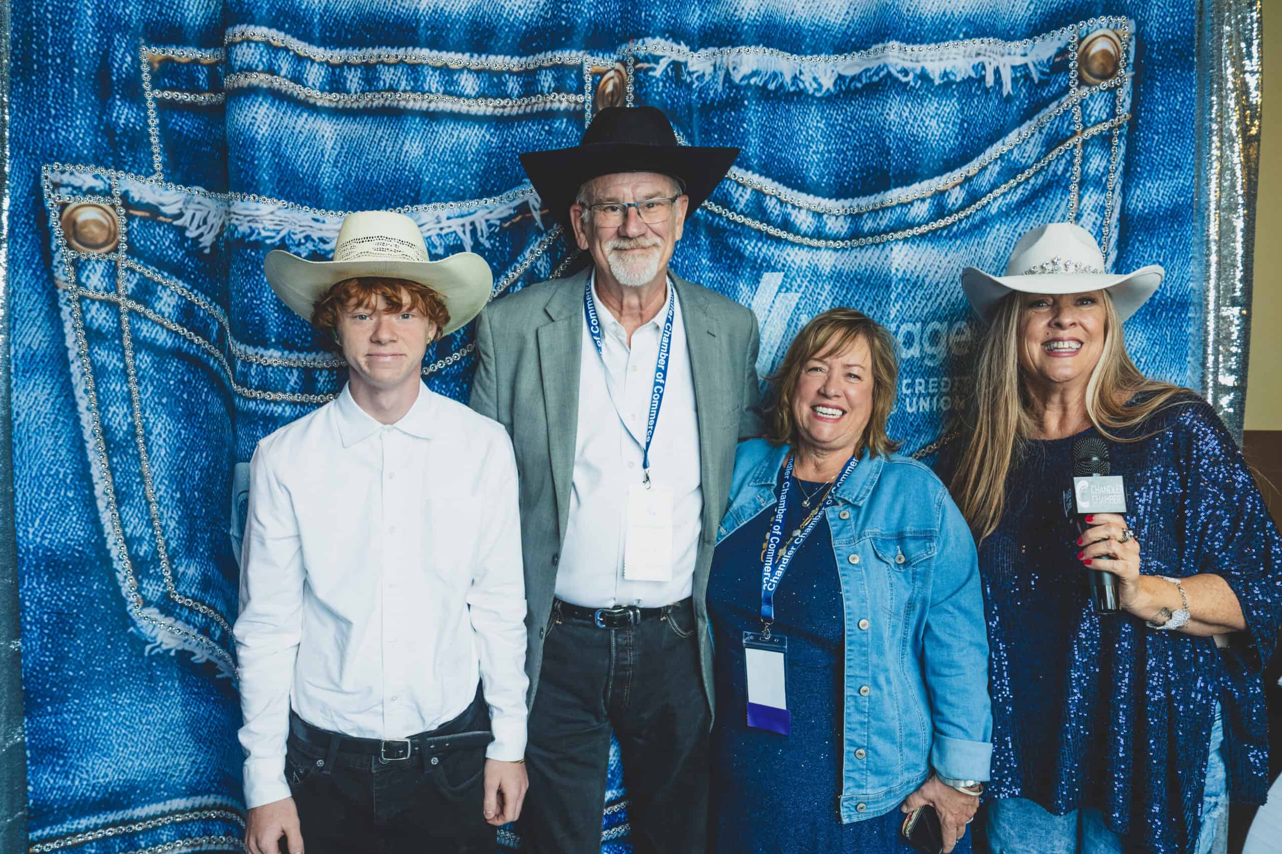 Harvey Gibson of Landings Credit Union with his grandson and guests at the denim photo backdrop