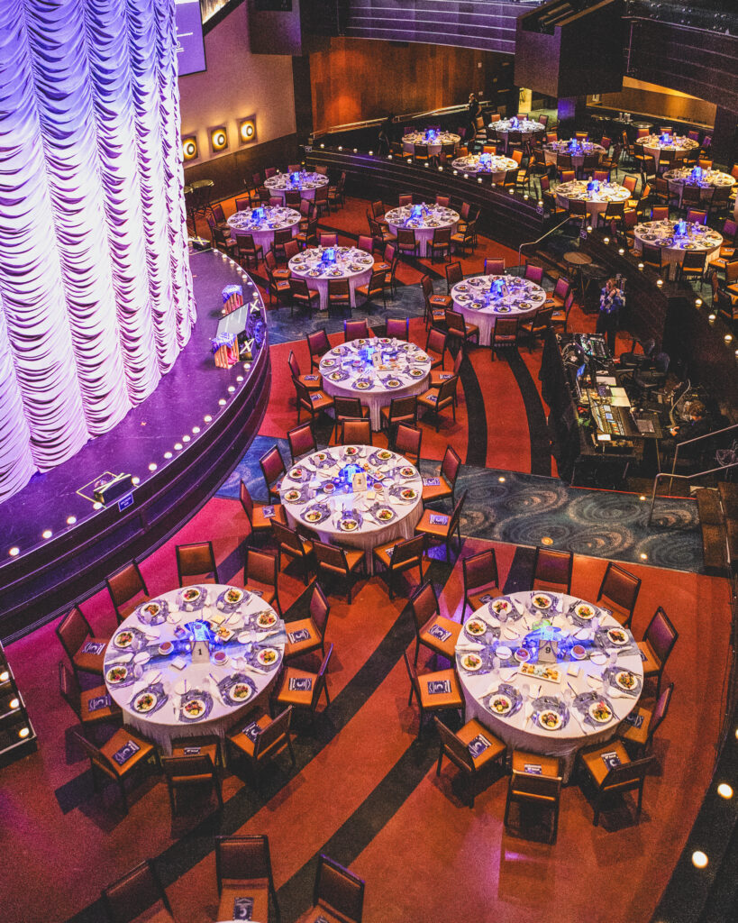Overhead view of round banquet tables set with blue lighting at Gila River Resorts & Casinos for the 39th Annual Chandler Chamber Community Awards
