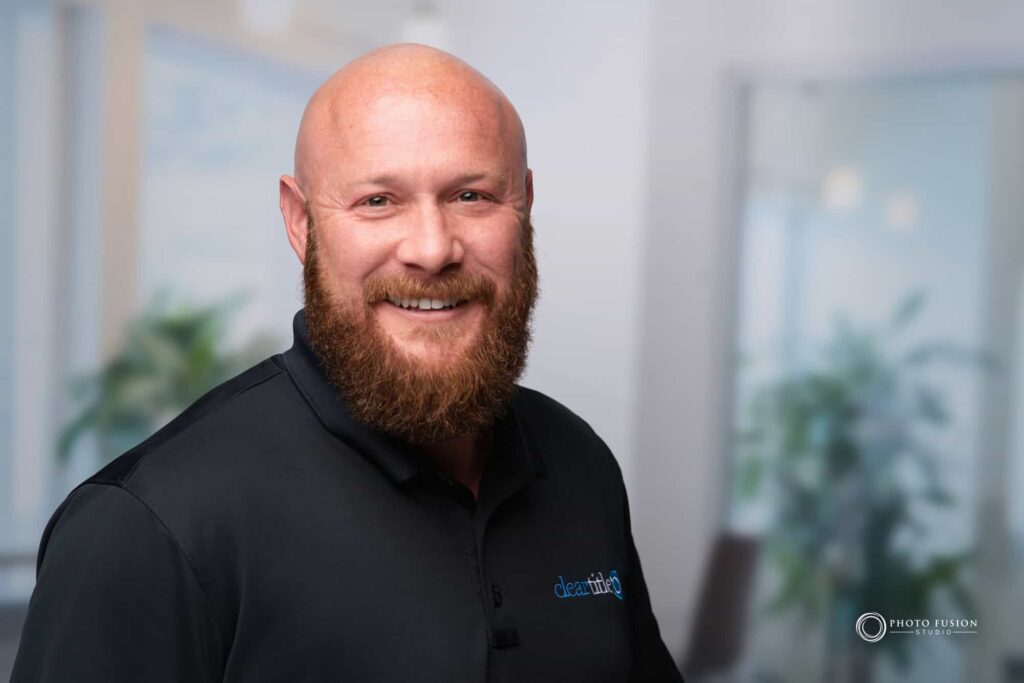 Man smiling at the camera getting his headshot taken at a headshot station.