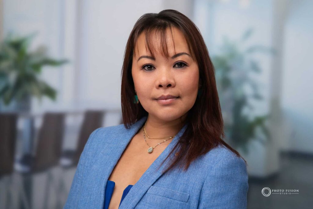Woman smiling at the camera getting his headshot taken at a headshot station.