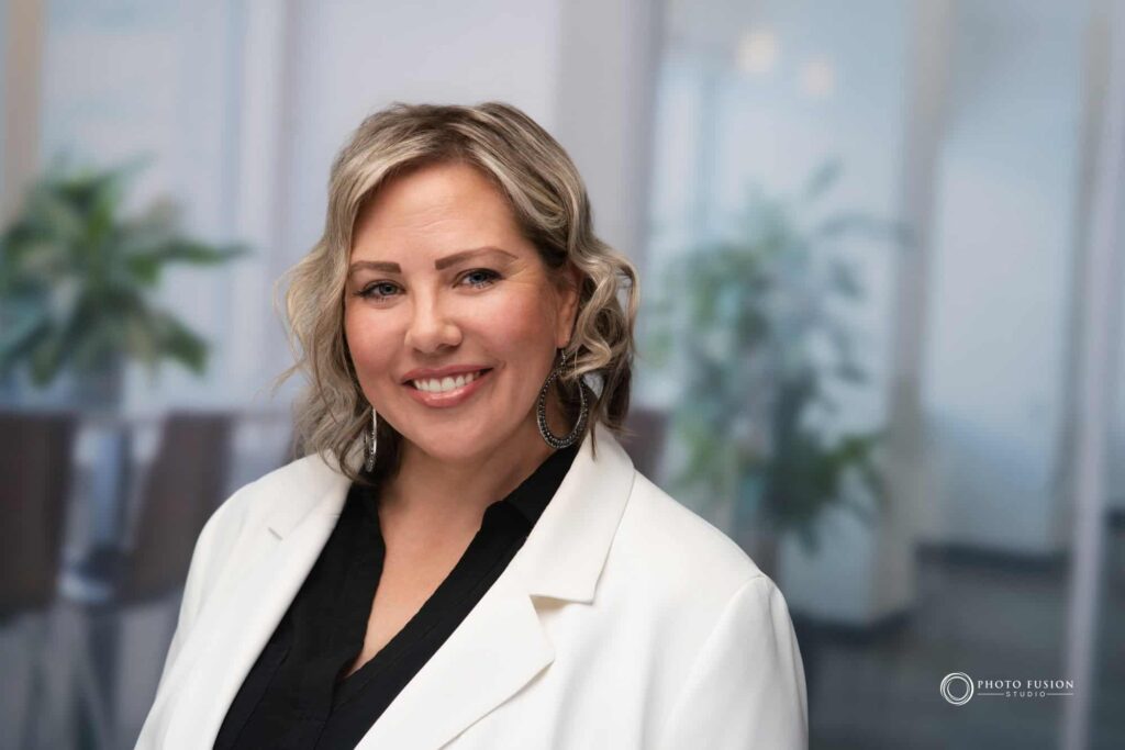 Woman smiling at the camera getting his headshot taken at a headshot station.