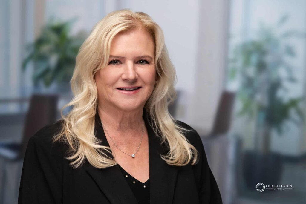 Woman smiling at the camera getting his headshot taken at a headshot station.