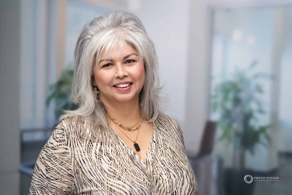 Woman smiling at the camera getting his headshot taken at a headshot station.
