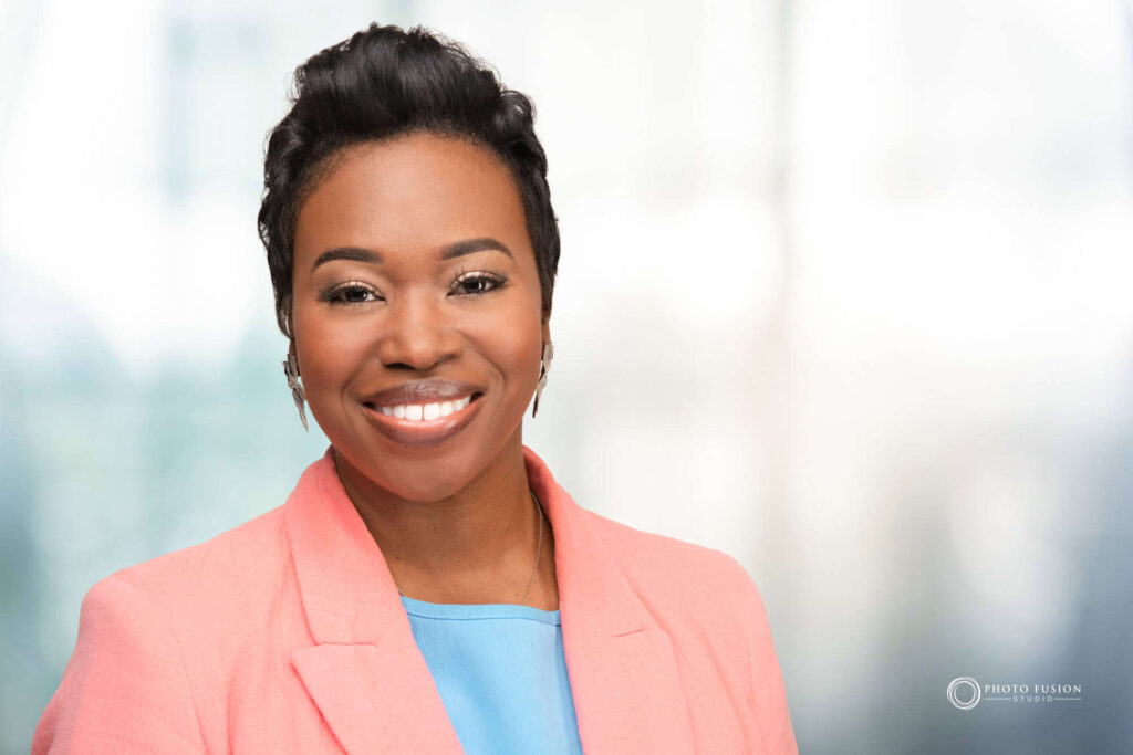 Woman smiling at the camera getting his headshot taken at a headshot station.