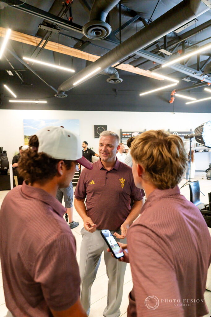 ASU head coach Matt Thurmond talks with two players on the True Spec Golf showroom floor