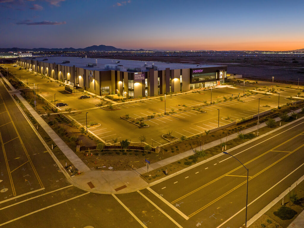 XNRGY facility at twilight with Arizona mountain backdrop and vivid sunset sky near Mesa Gateway Airport.