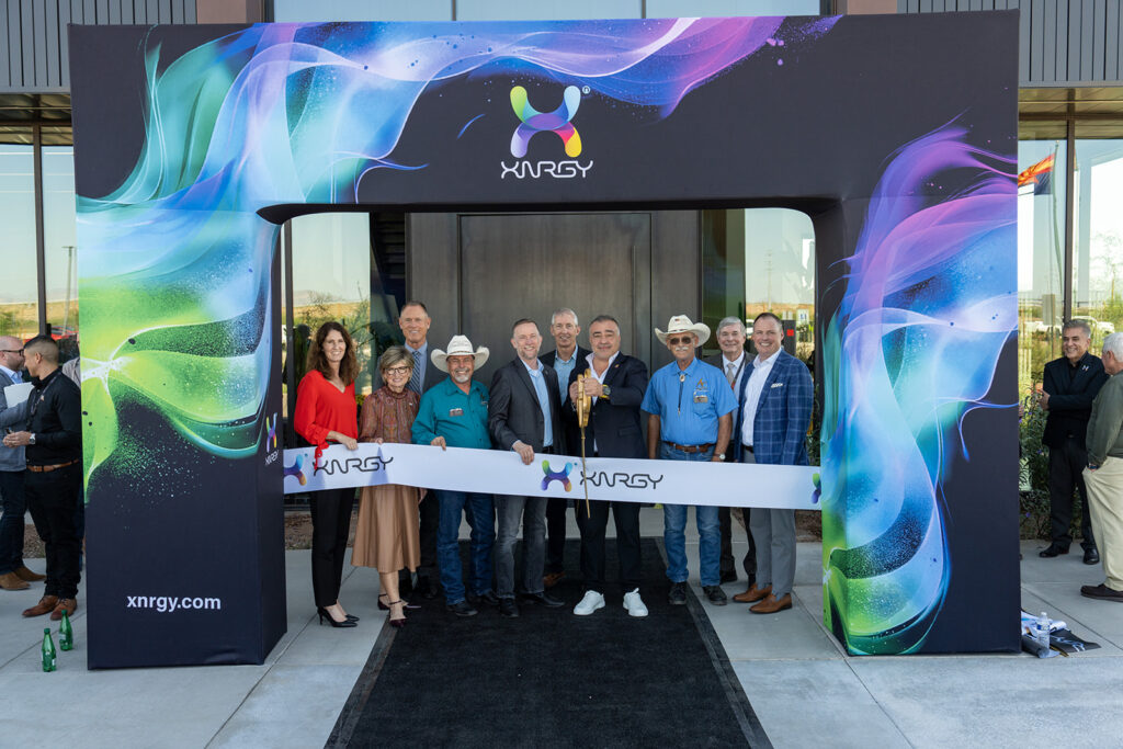 XNRGY CEO Wais Jalali with Arizona dignitaries and officials posed under the colorful XNRGY entrance arch at the ribbon cutting of the Mesa Gateway facility.